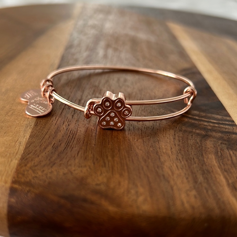 Alex and Ani dog paw print bangle in a shiny rose gold finish.